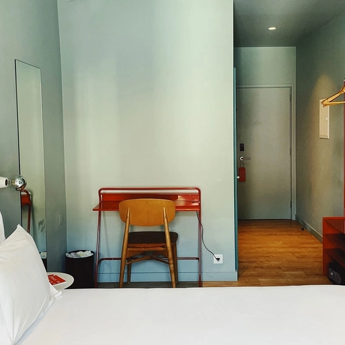 a bedroom with a desk and chair in it