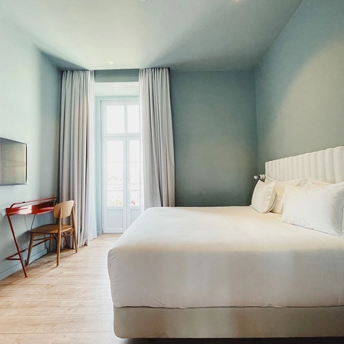 a hotel room with a large bed and a desk