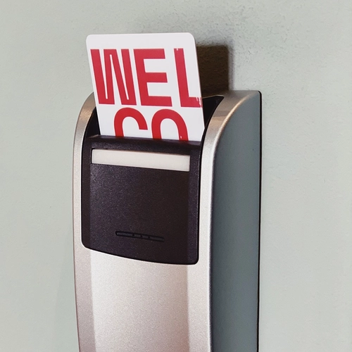 a salto card reader with a welcome card sticking out of it