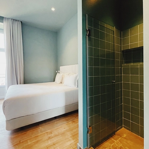 a bedroom with a bed and a walk in shower