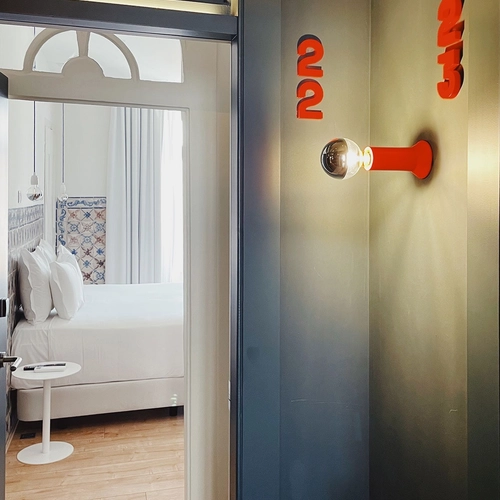 a bedroom with a red light and a sign that says ' cucu ' on it