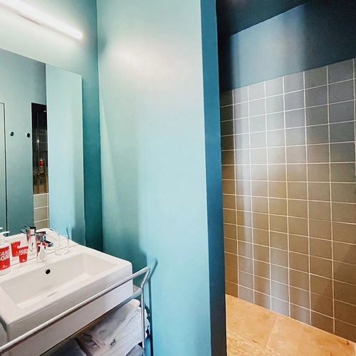 a bathroom with a sink and a mirror and a soap dispenser that says soap box