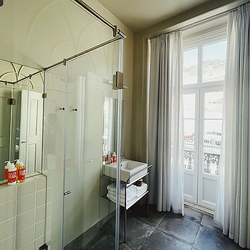 a bathroom with a sink and a glass shower