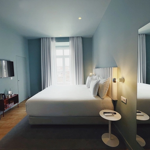 a hotel room with a king size bed and a flat screen tv