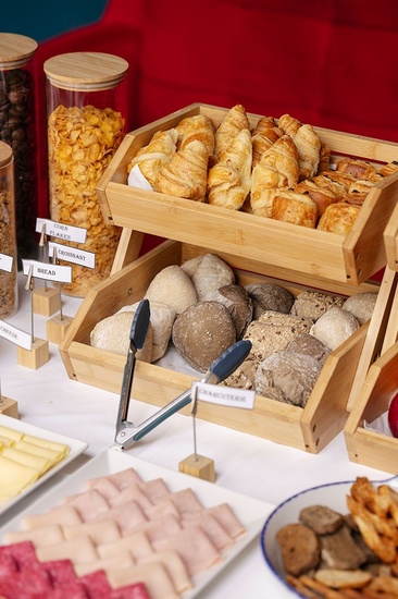 a buffet table with bread and croissants on it