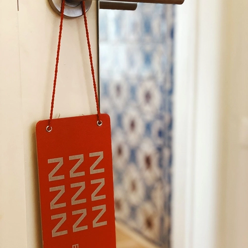 a red sign that says nnn on it hangs on a door