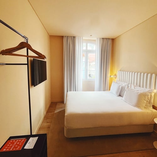 a hotel room with a large bed and a flat screen tv