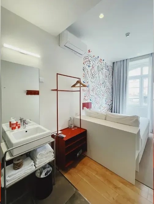 a hotel room with a sink and a couch
