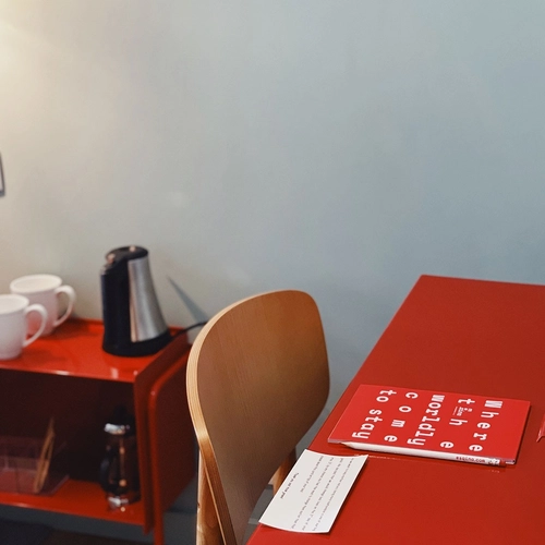 a red table with a sign on it that says 