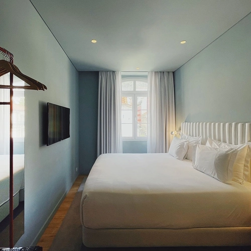 a hotel room with a king size bed and a flat screen tv