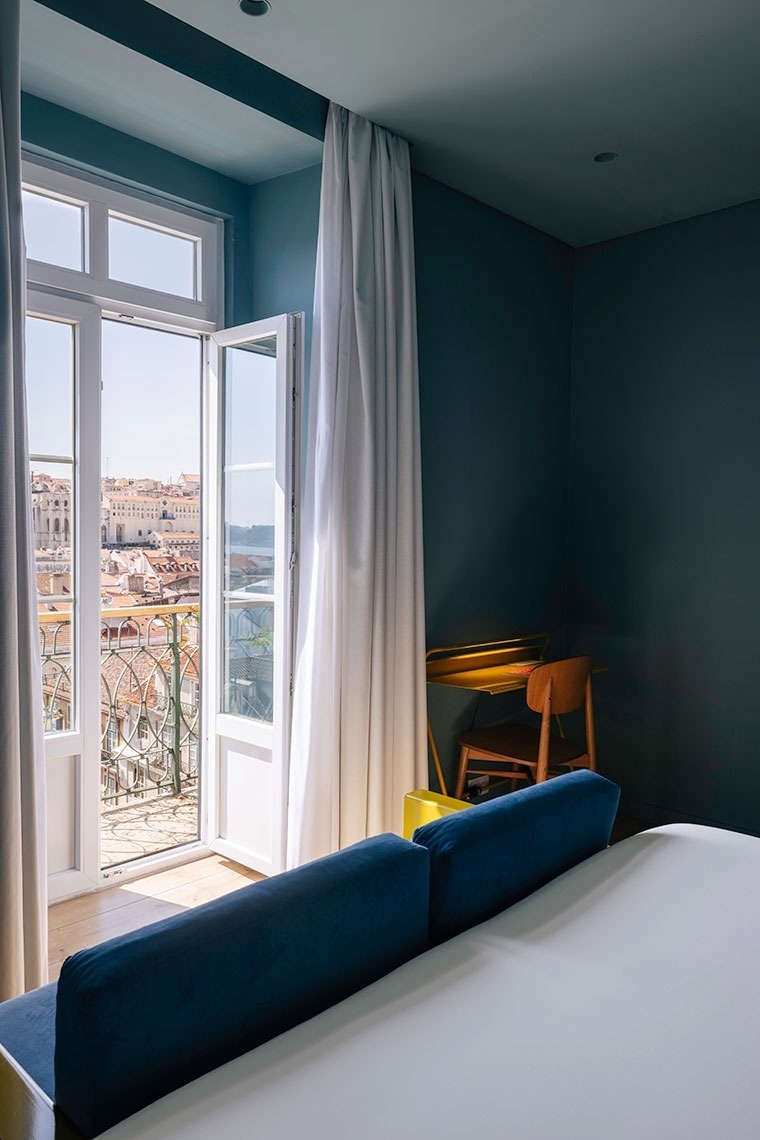a bedroom with a large bed and a balcony