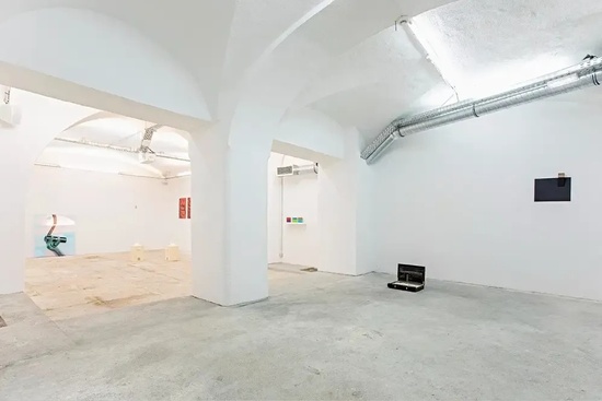 an empty room with a briefcase on the floor