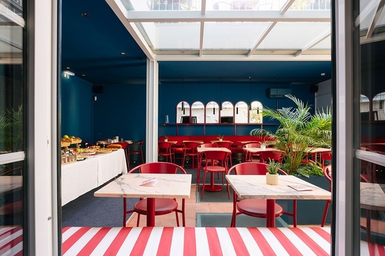 a restaurant with red and white tables and chairs