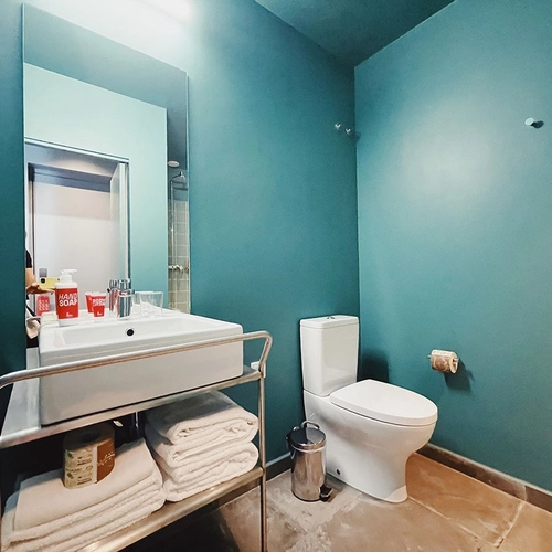 a bathroom with a toilet and a sink that says soap on it