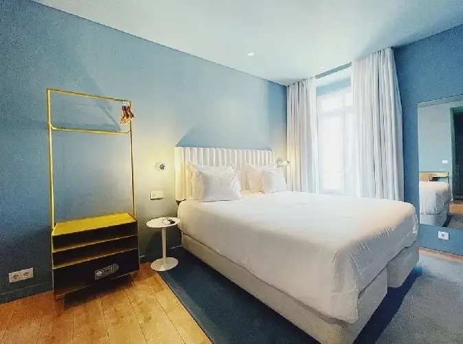 a hotel room with a bed and a mirror