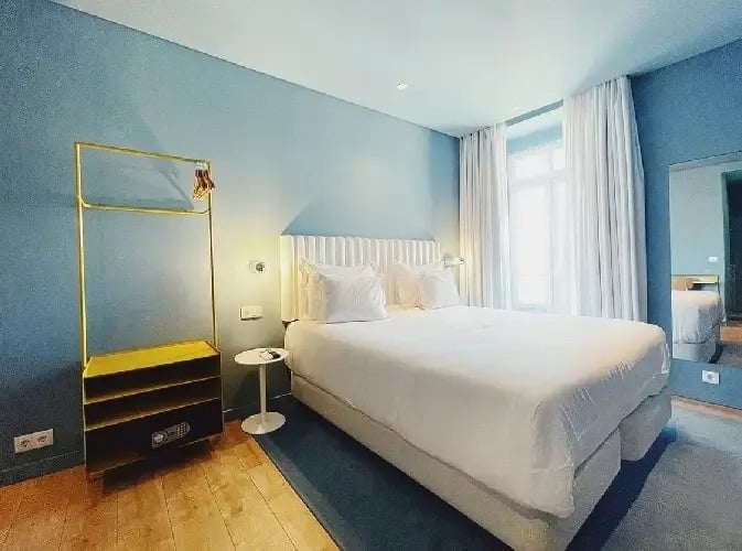 a hotel room with a bed and a mirror