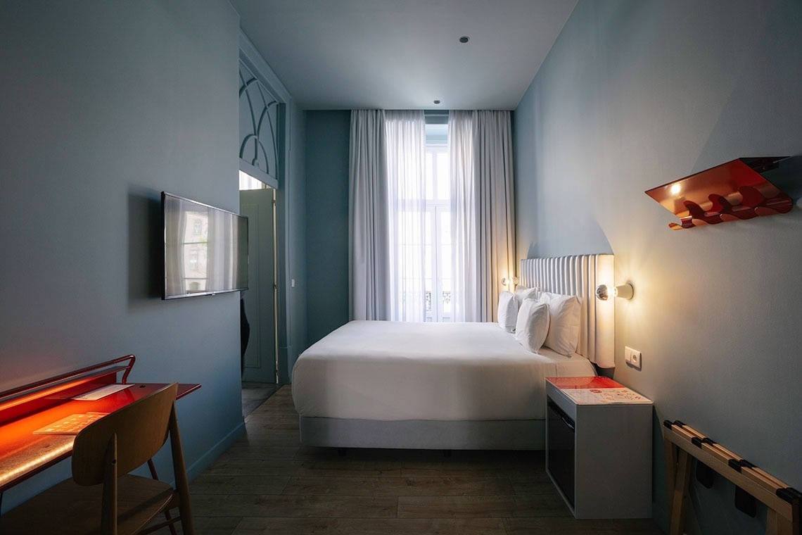 a hotel room with a king size bed and a flat screen tv