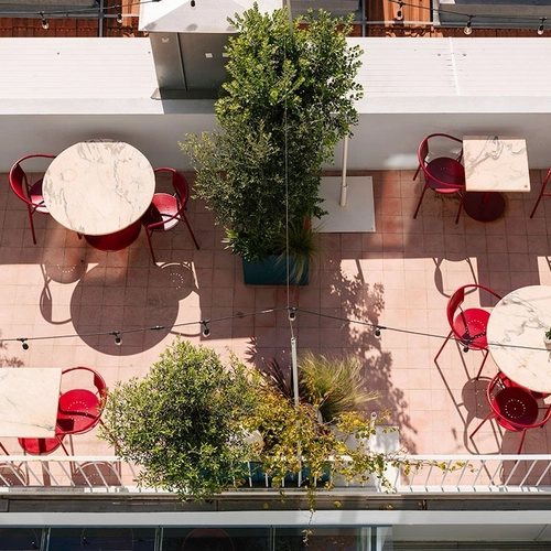 an aerial view of a patio with tables and chairs