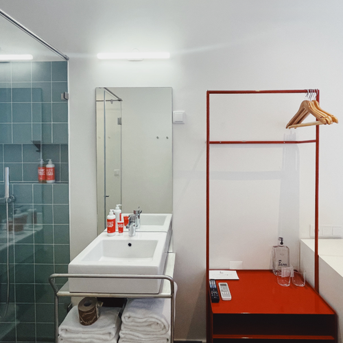 a bathroom with two sinks and a painting on the wall