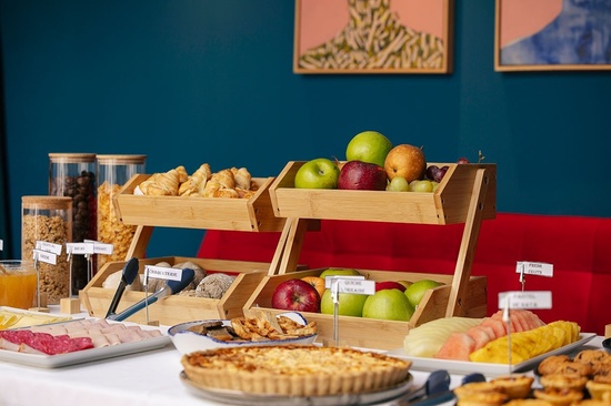 a buffet table with a variety of food including a quiche
