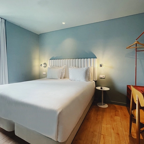 a hotel room with a bed and a desk