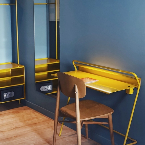 a yellow desk with a magazine on it