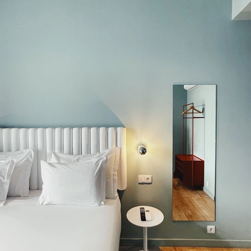 a hotel room with a bed and a mirror