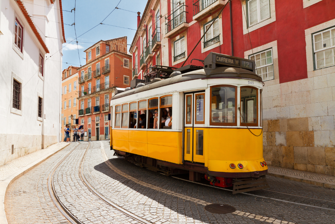 um ônibus com o número 28 ao lado de um prédio verde