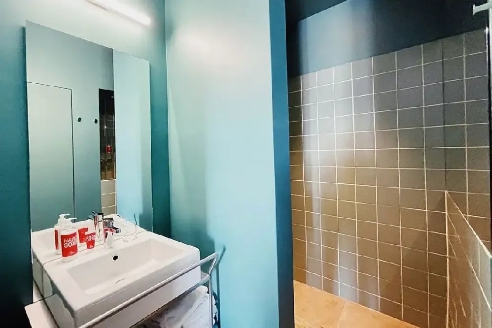 a bathroom with a sink a mirror and a soap dispenser that says soap on it