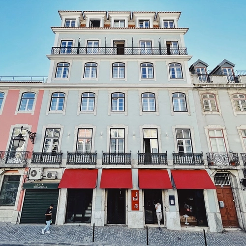 a building with a red awning that says ' a ' on it