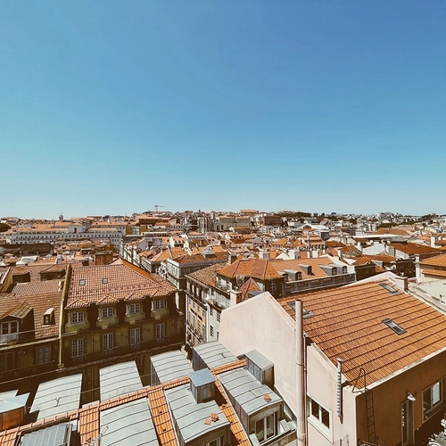 an aerial view of a city with lots of buildings and roofs