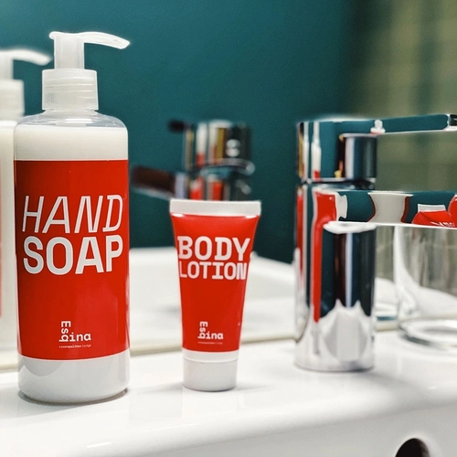 a bottle of hand soap sits next to a bottle of body lotion