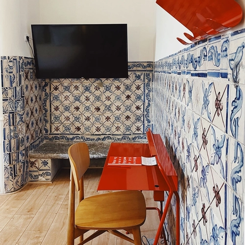 a chair sits in front of a red desk with a book on it that says 