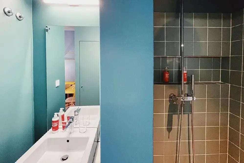 a bathroom with a sink a mirror and a shower