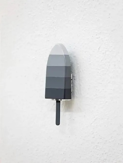 a black and white popsicle is hanging on a white wall .