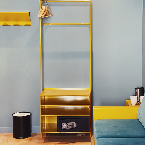 a yellow shelf with a safe underneath it