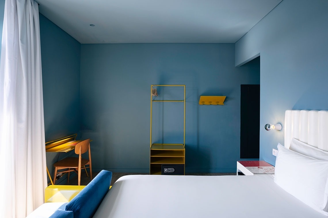 a bedroom with blue walls and a bed