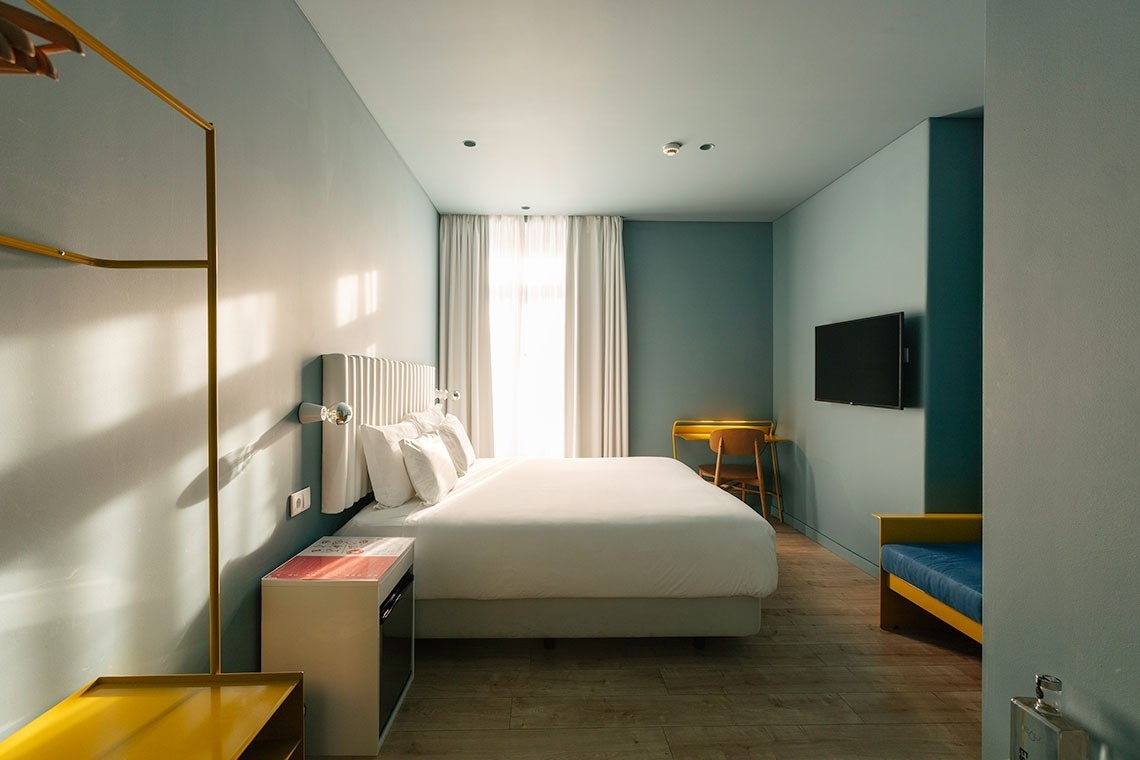 a hotel room with a bed and a safe