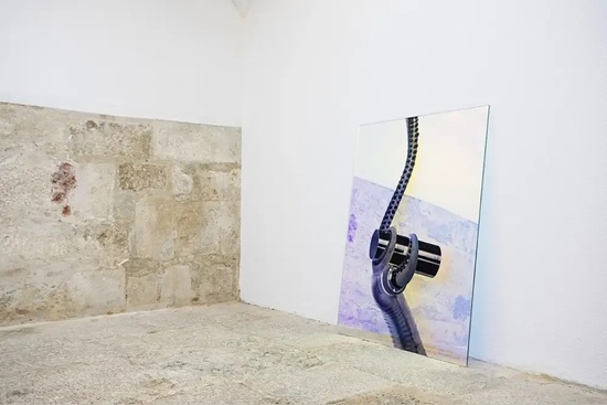 a painting of a chain is hanging on a white wall