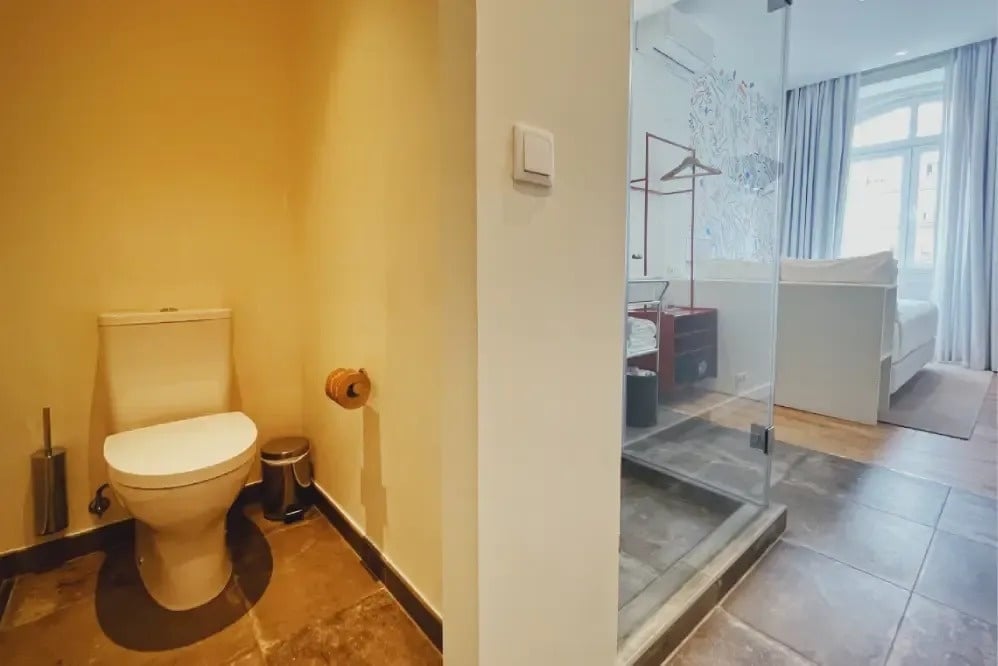 a bathroom with a toilet and a walk in shower