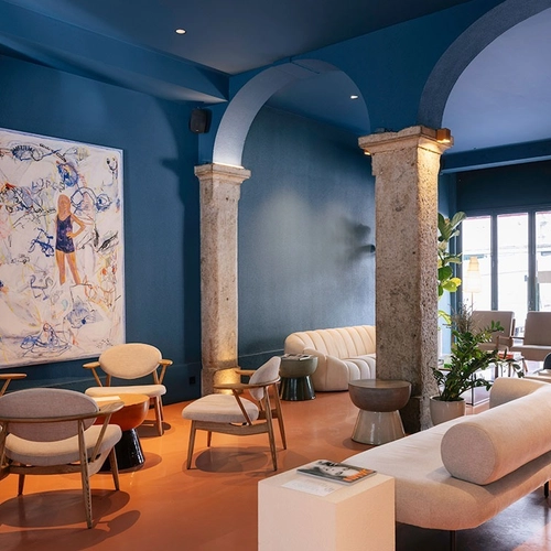 a room with blue walls and a painting on the wall