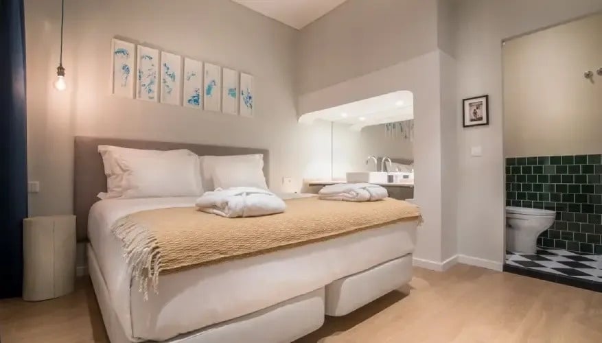 a bedroom with a large bed and a toilet