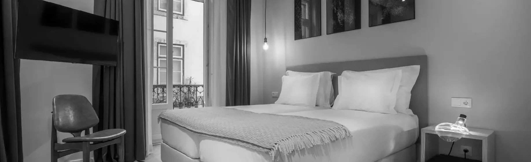 a black and white photo of a hotel room