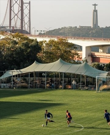 a woman sits at a table in a restaurant with a laptop