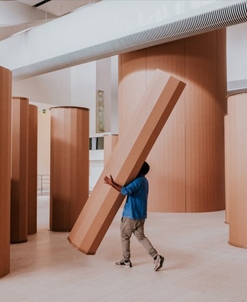 a black and white photo of a group of people in a bar with a coca cola sign on the wall