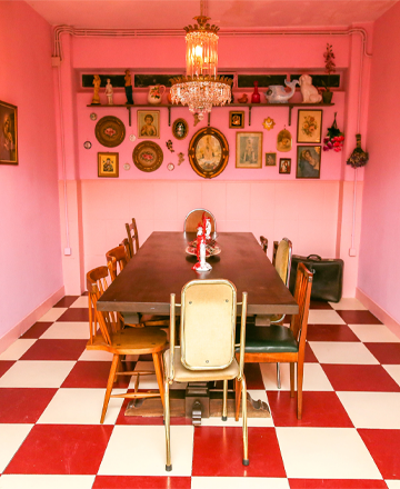 a woman sits at a table in a restaurant with a laptop