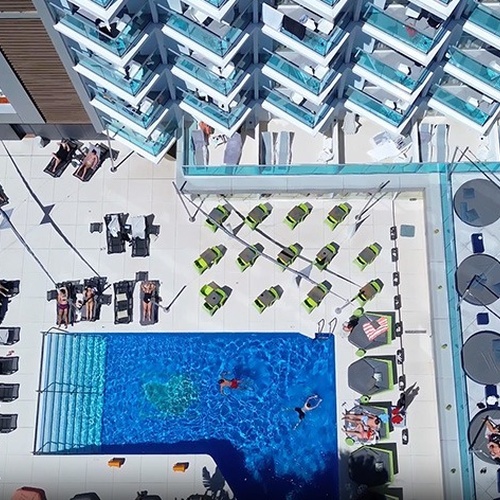 an aerial view of a hotel with a large pool
