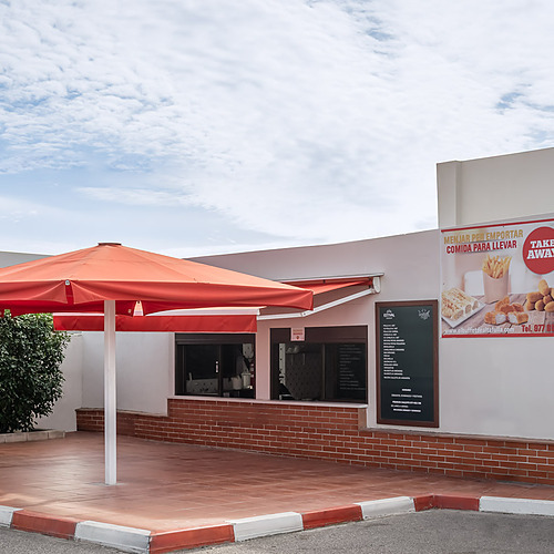 Take away restaurant with outdoor seating and signage for ESTIVAL: D Altafulla.
