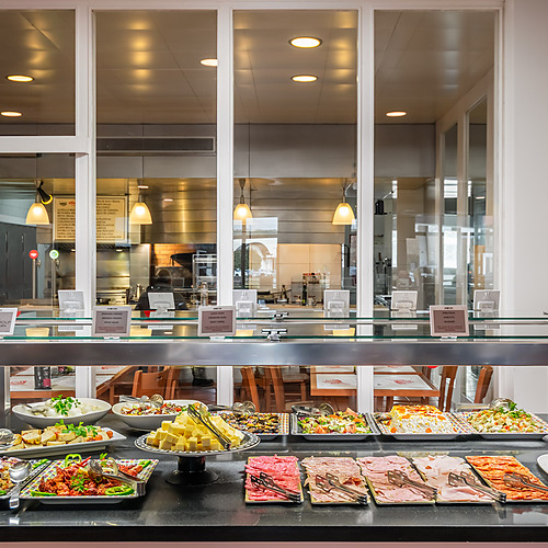 Hotel buffet with diverse salads, cheeses, and cured meats, showcasing ESTIVAL: D Altafulla dining options.