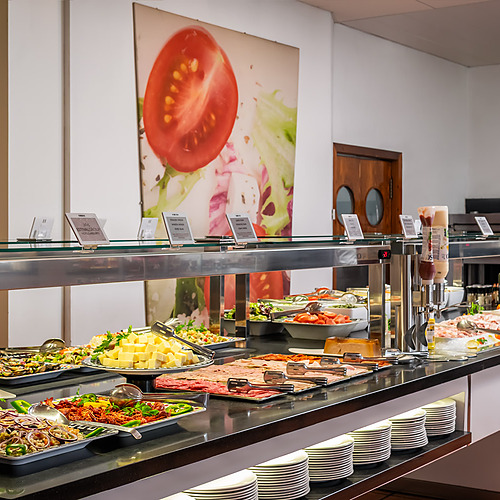 Buffet display at ESTIVAL: D Altafulla hotel, featuring salads, cheeses, cold cuts, and seafood.